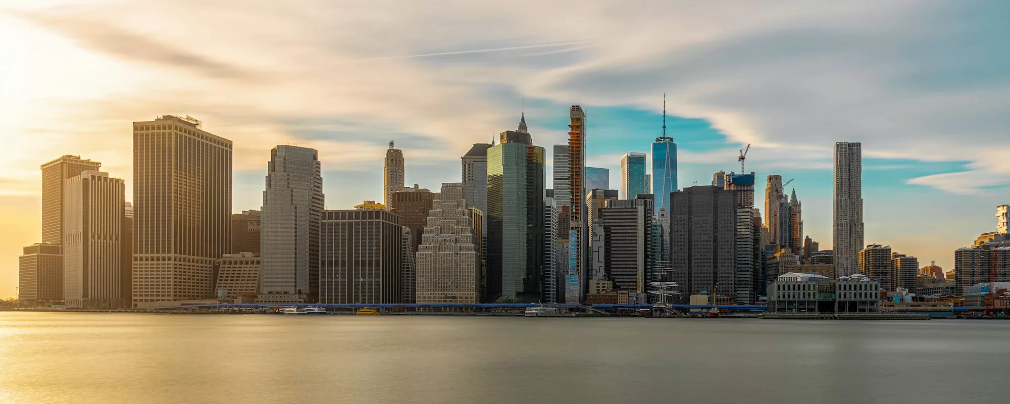 Banner and Panorama of New york Cityscape with Brooklyn Bridge over the east river at the evening